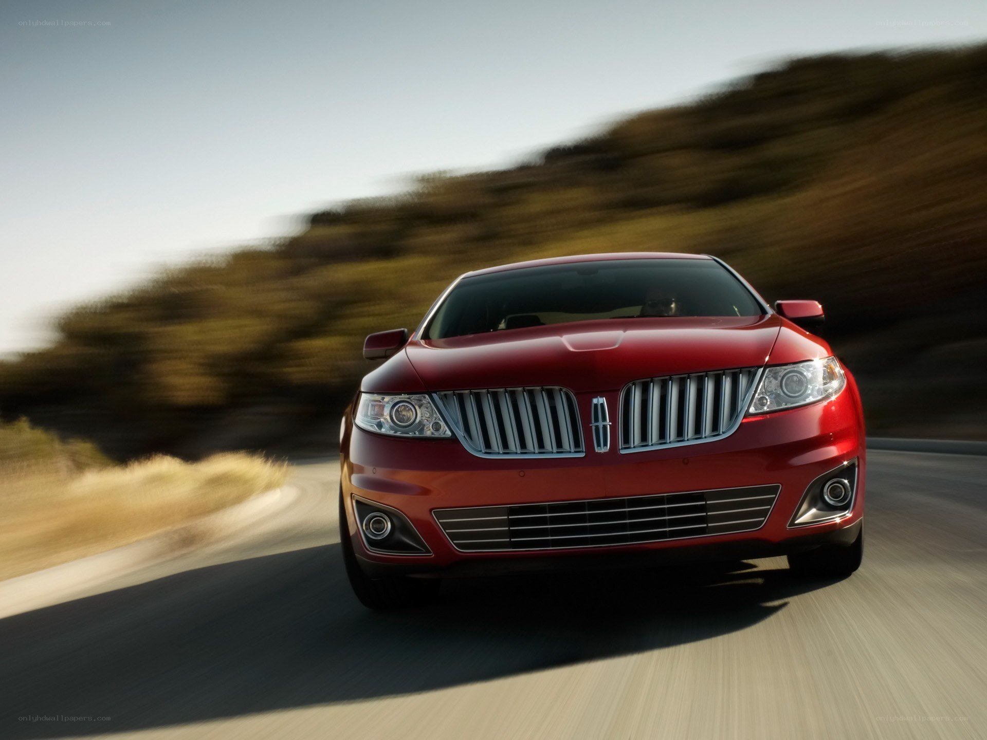 red lincoln driving on road
