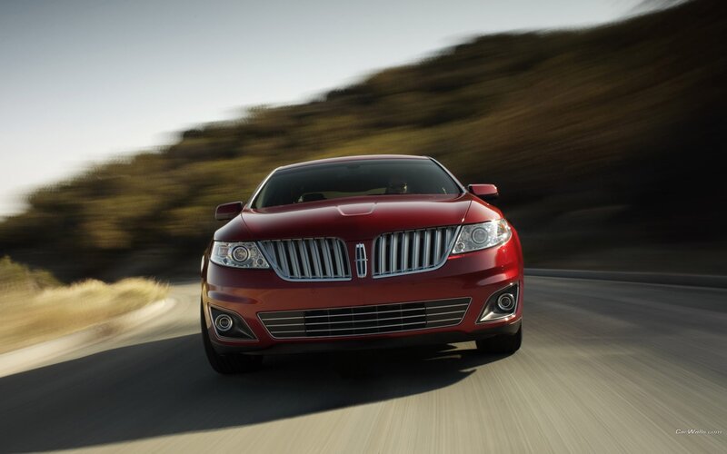 red lincoln driving on road