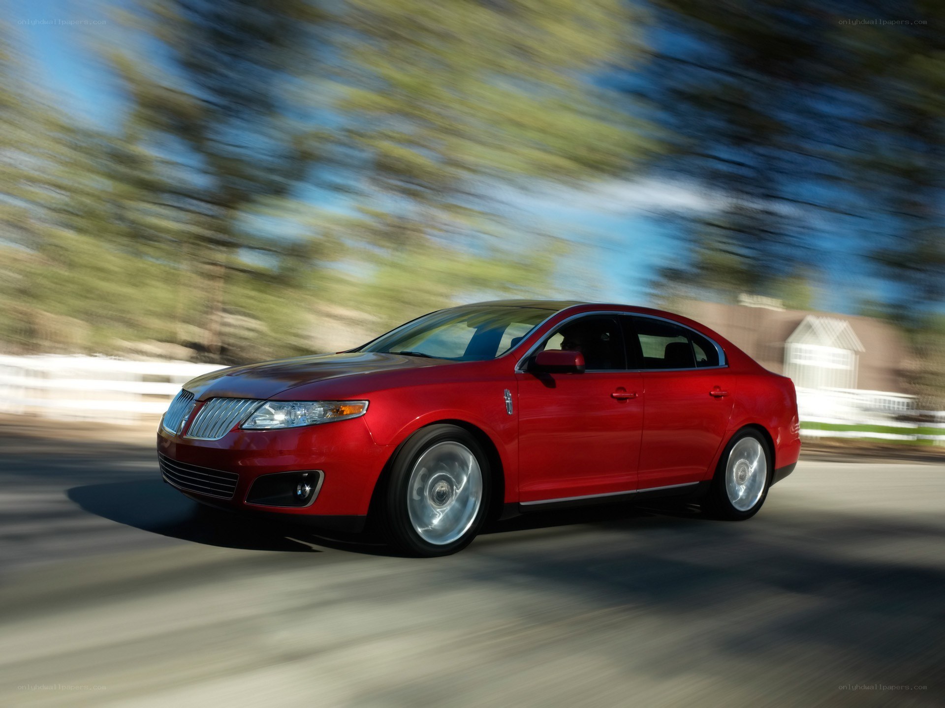 Red Lincoln MKZ in motion