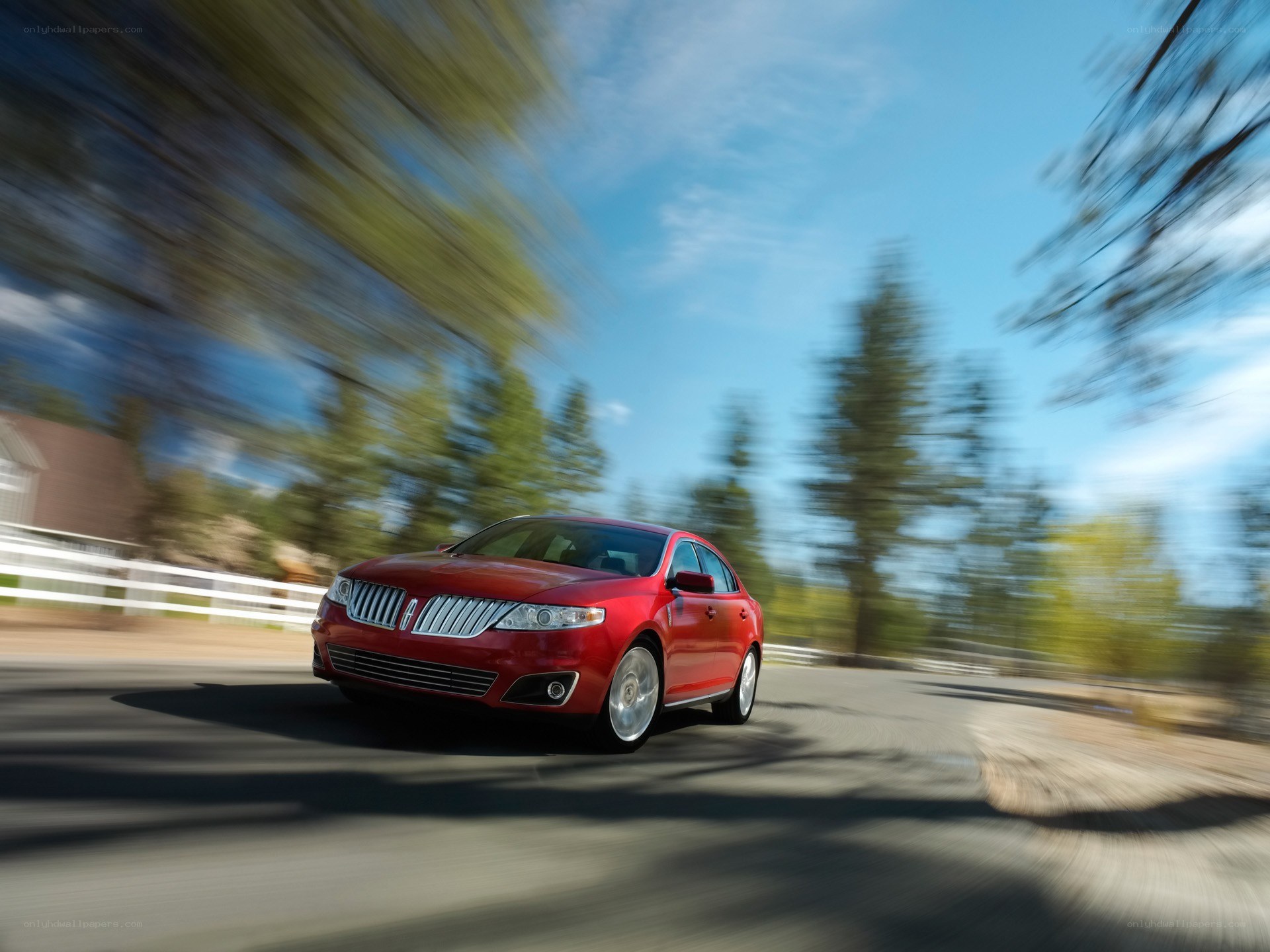 Red Lincoln sedan in motion