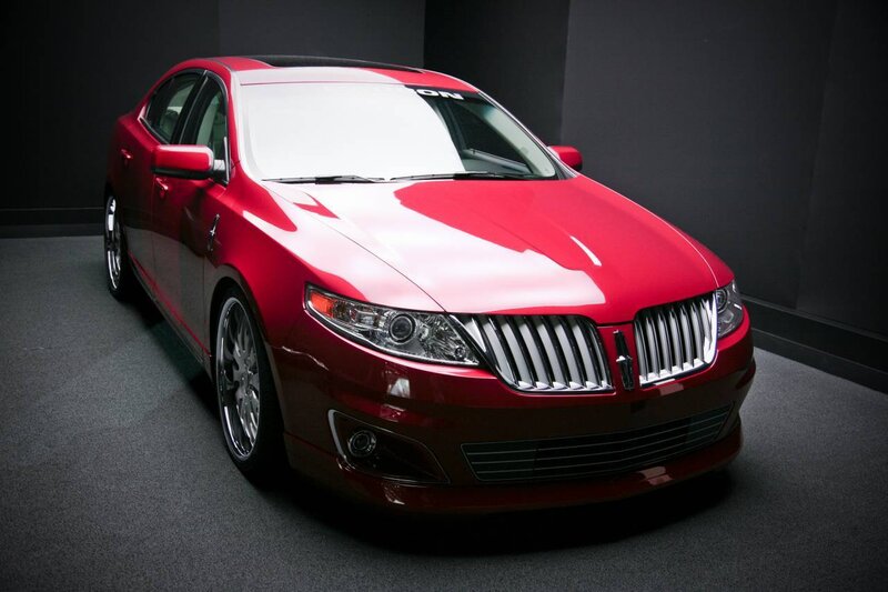 Red Lincoln sedan in showroom