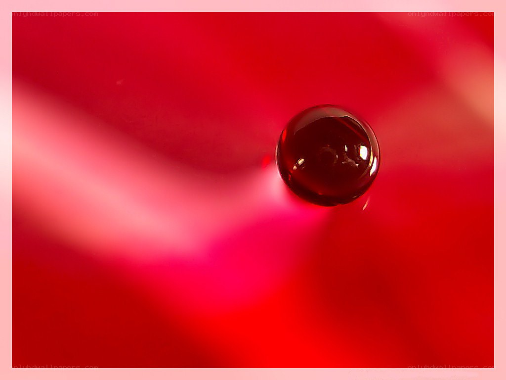red liquid drop on red surface