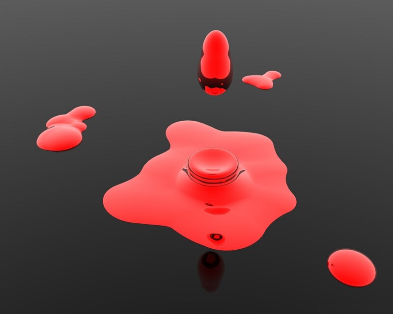 Red liquid spill on dark surface