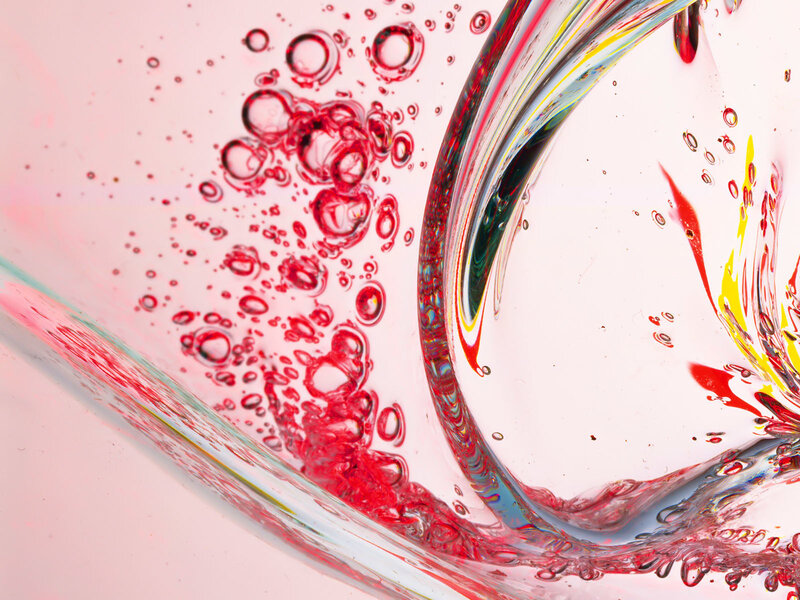 Red liquid swirling in glass