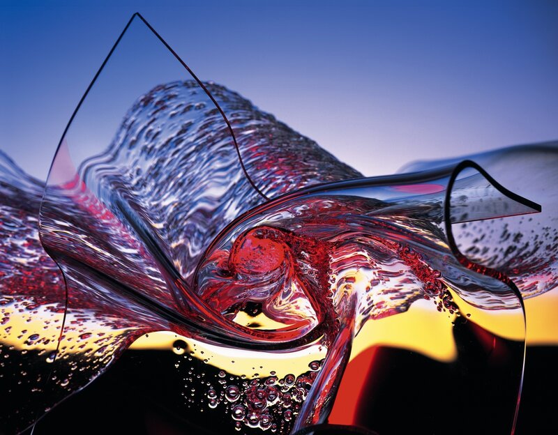 Red liquid swirling in glass