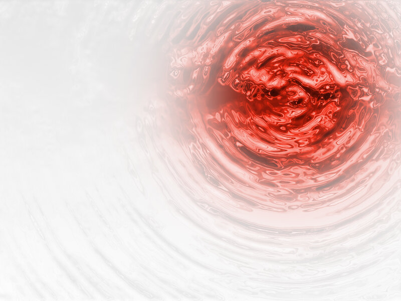 red liquid swirling in water