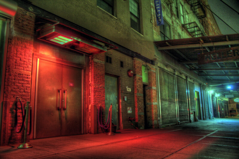 Red-lit alleyway at night