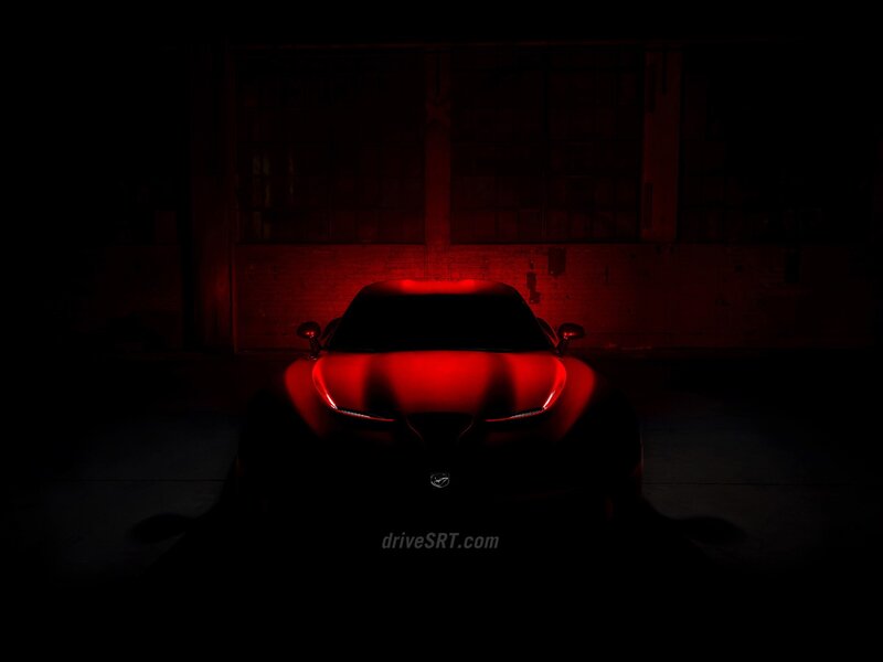 Red-lit car in dark garage