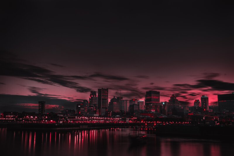 red-lit city skyline at dusk