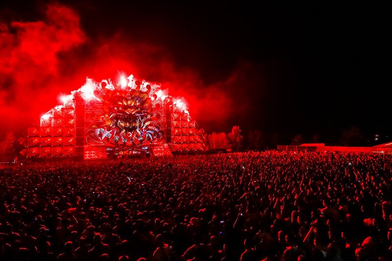 Red-lit concert crowd at night