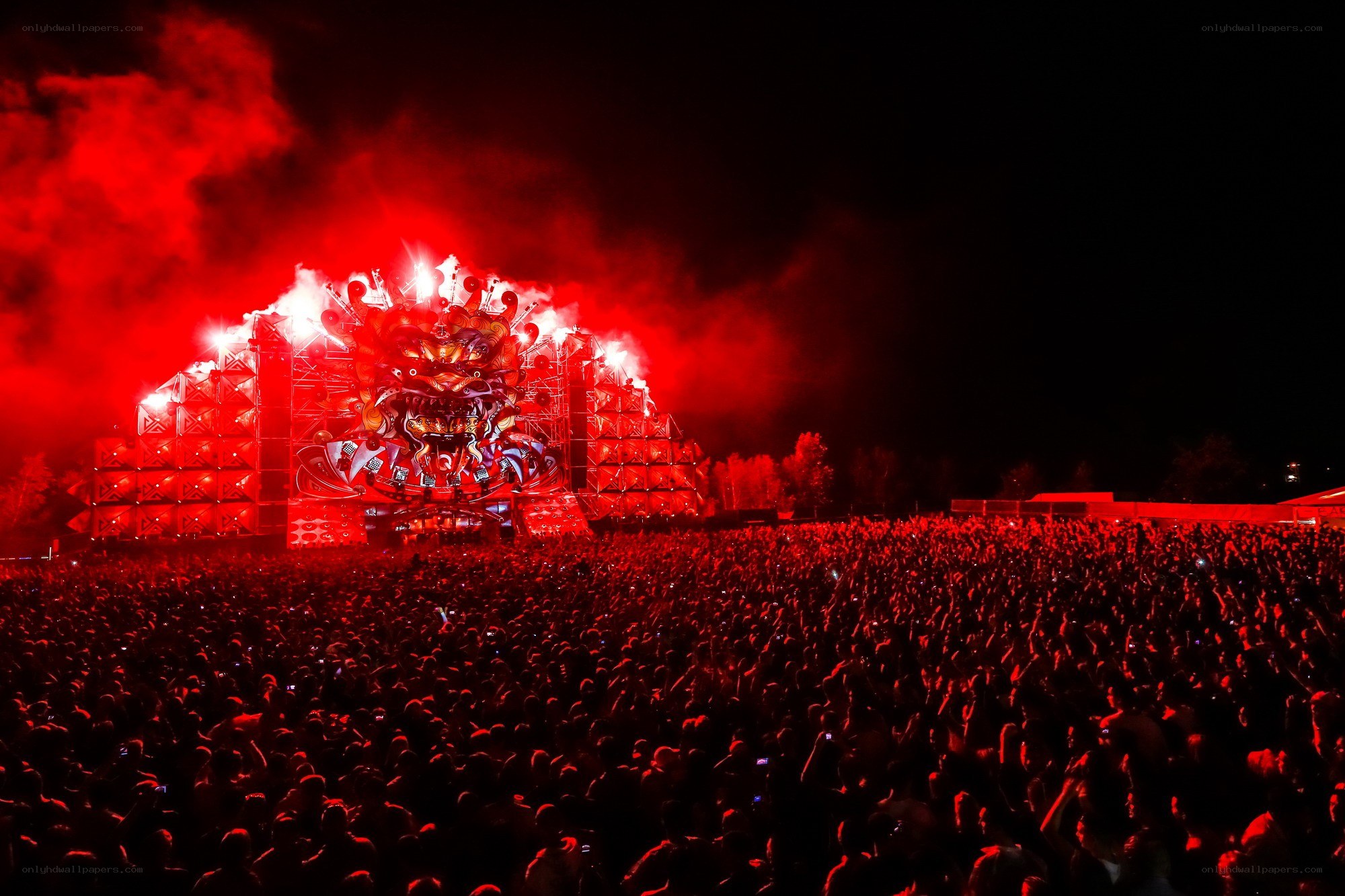Red-lit concert crowd at night