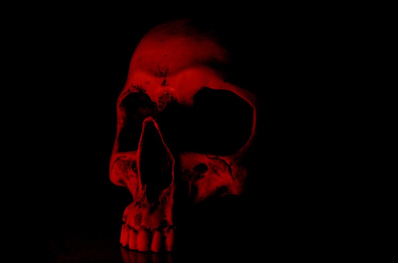 red-lit skull in darkness