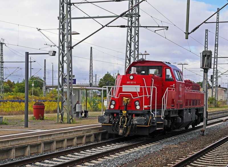 Red locomotive at train station