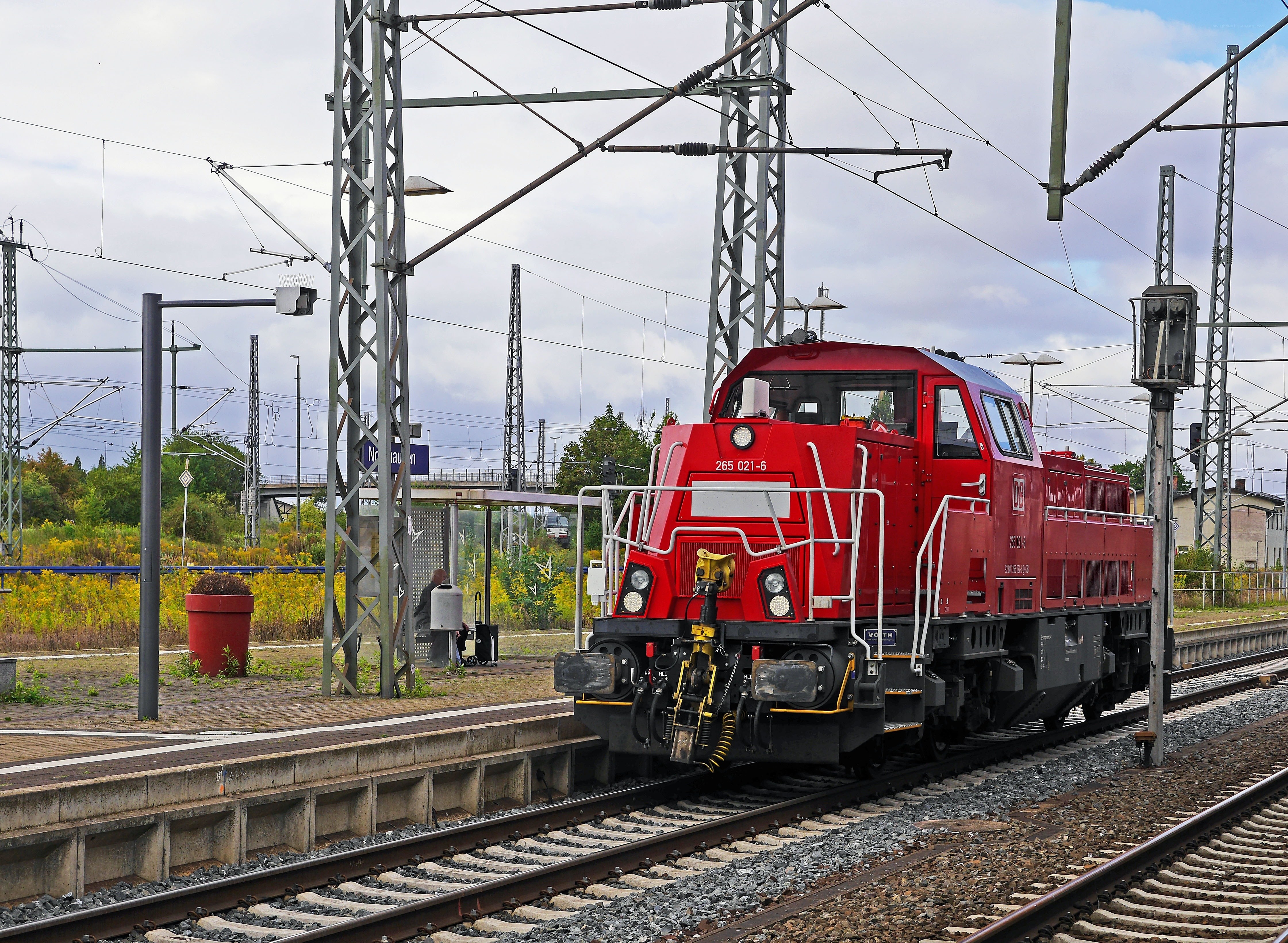 Red locomotive at train station
