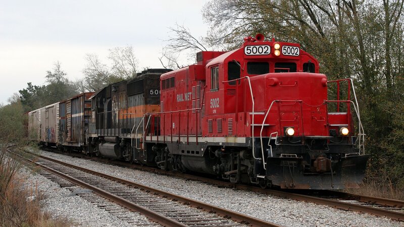 Red locomotive pulling freight train