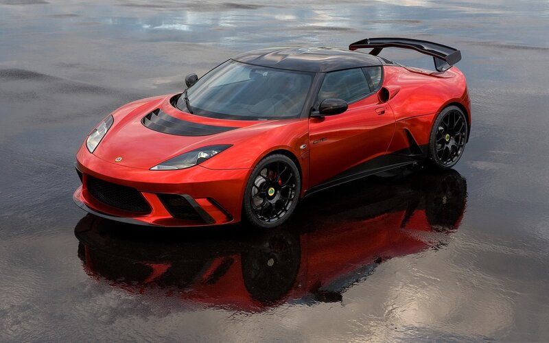 Red Lotus sports car on wet surface