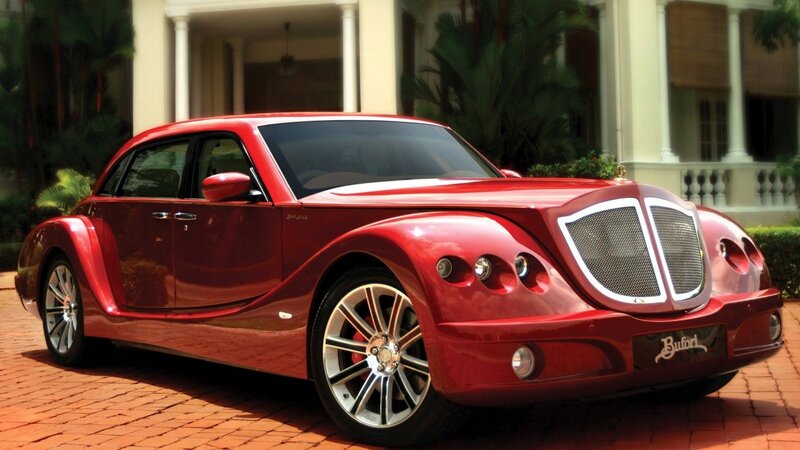 Red luxury car on brick driveway