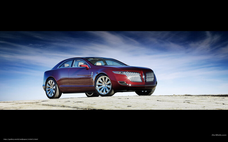 Red luxury sedan on desert hill