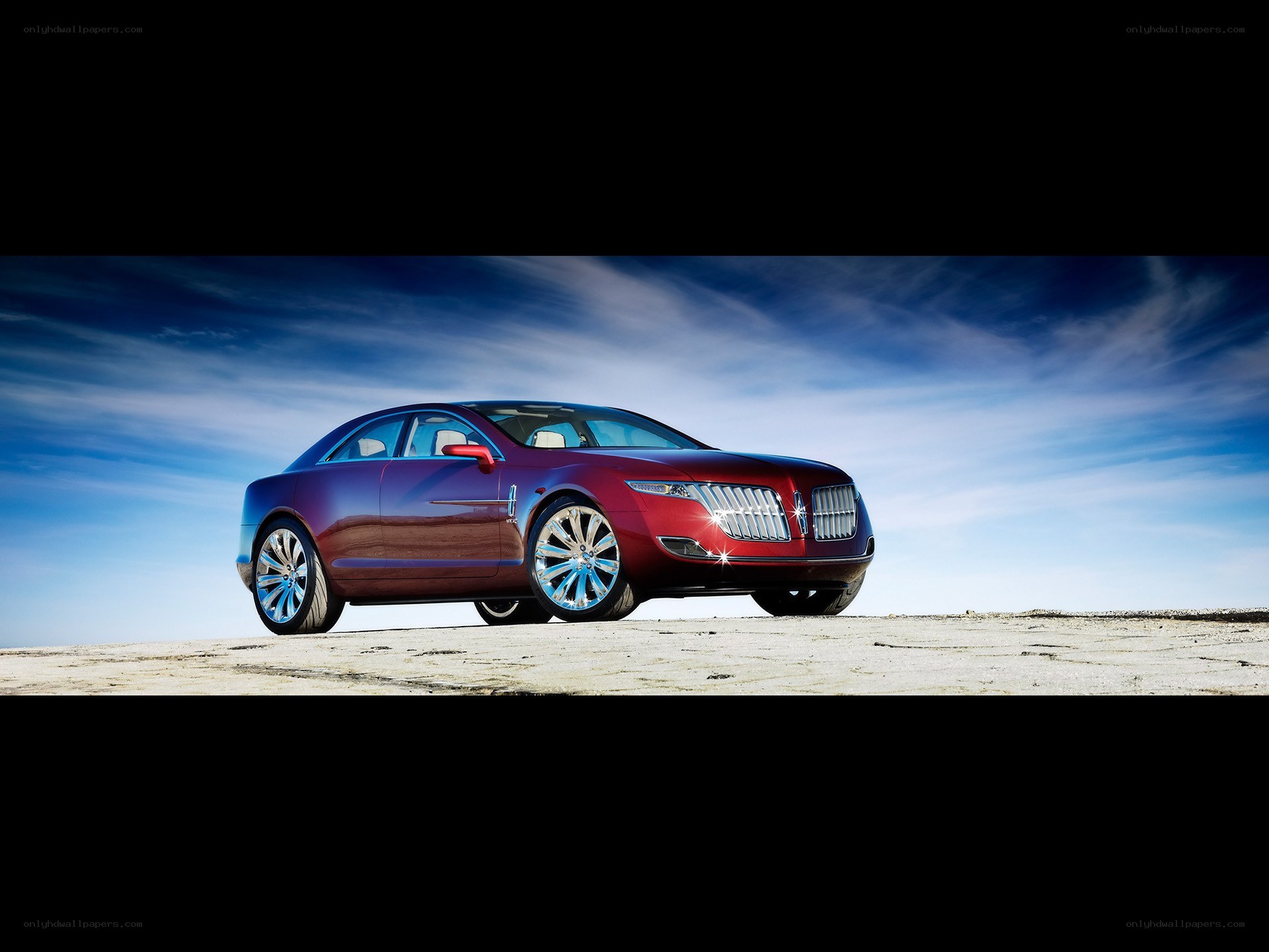 Red luxury sedan on desert plain