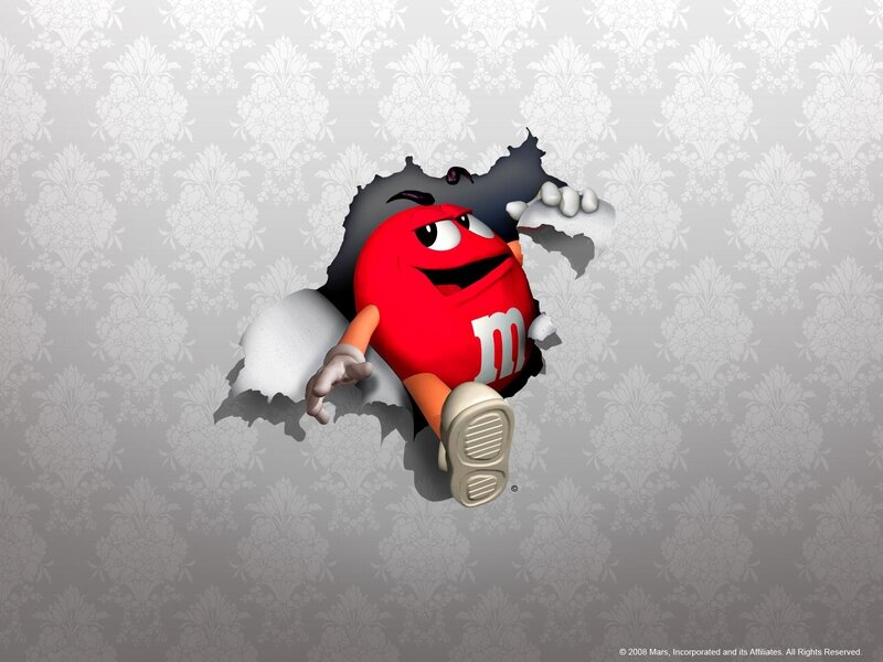 Red M&M breaking through wall