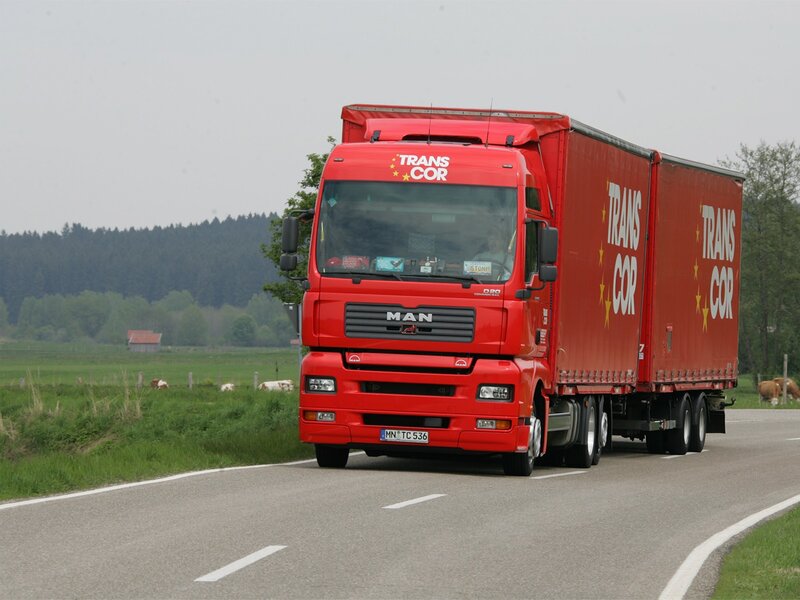 Red MAN truck on a country road