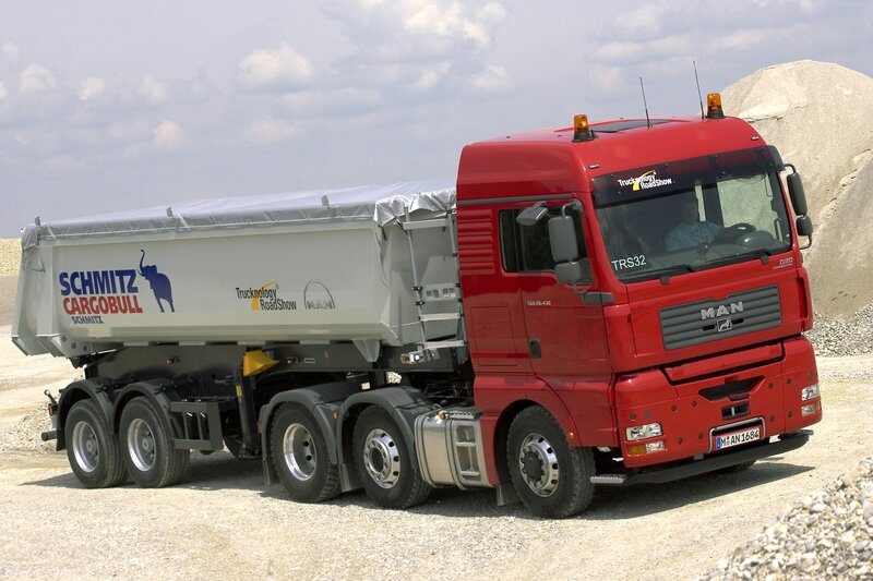Red MAN truck with Schmitz trailer
