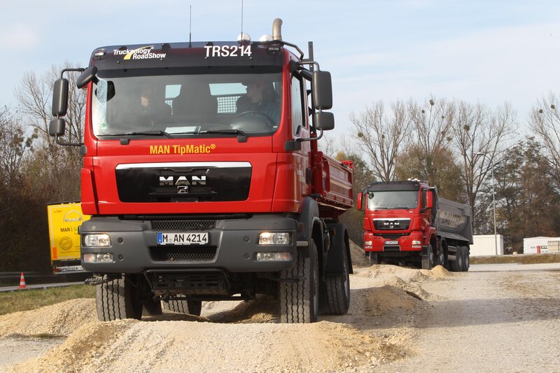 Red MAN trucks at a roadshow