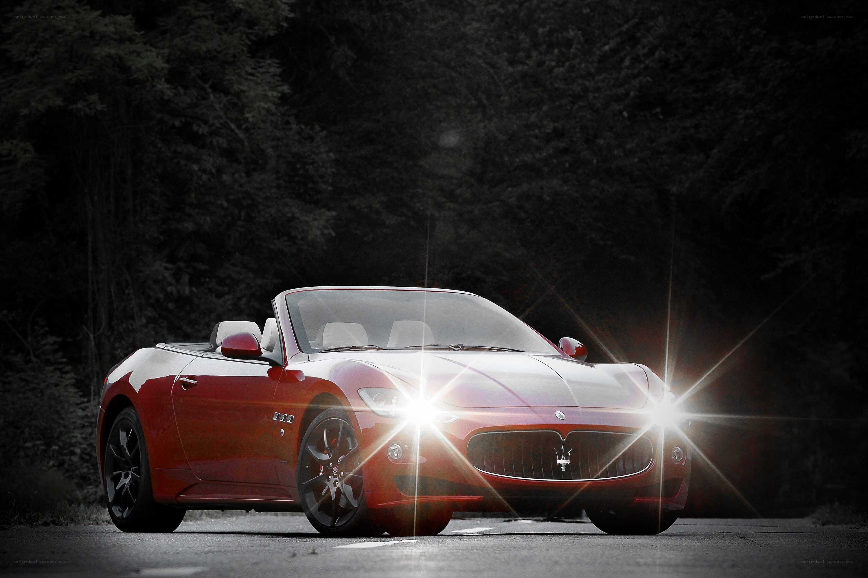 Red Maserati convertible at night