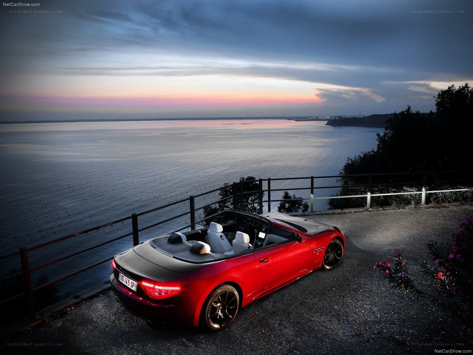 Red Maserati convertible at sunset