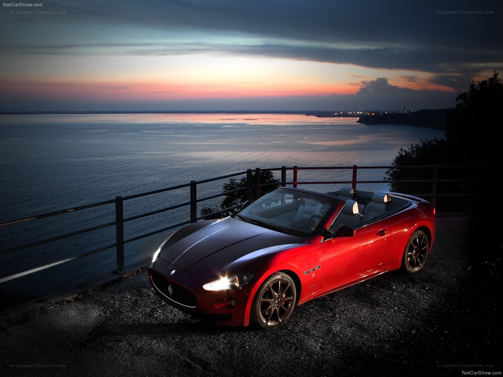 Red Maserati convertible at sunset