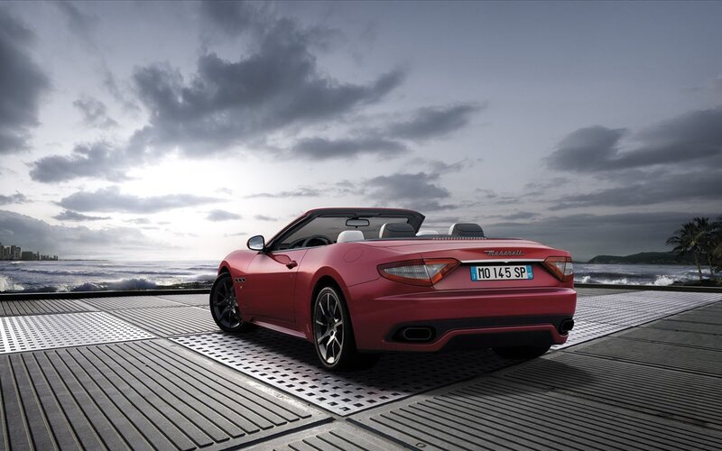 Red Maserati convertible by the sea
