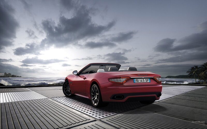 Red Maserati convertible by the sea