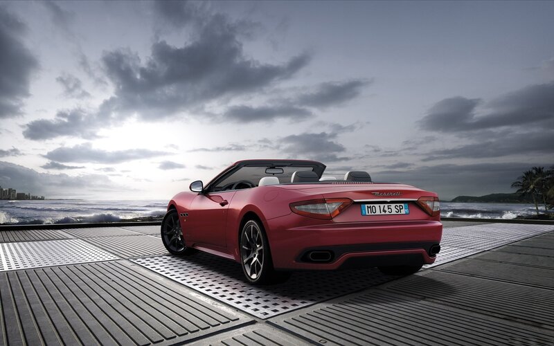 Red Maserati convertible by the sea