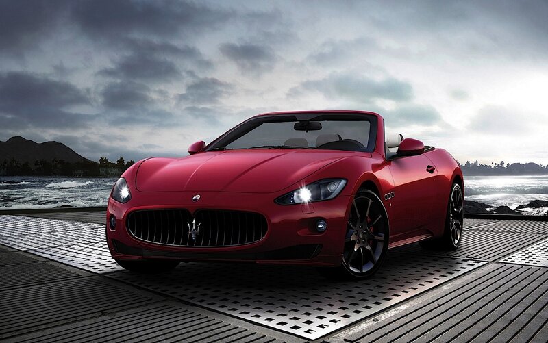 Red Maserati convertible by the sea