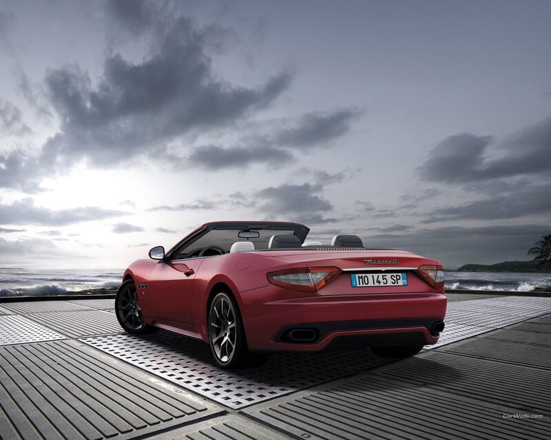 Red Maserati convertible by the sea