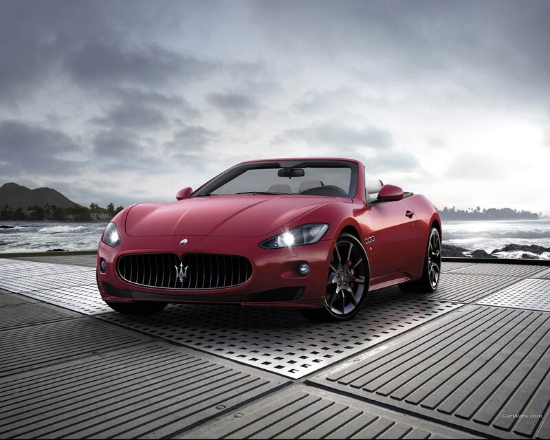 Red Maserati convertible by the sea