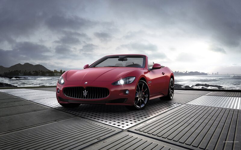 Red Maserati convertible by the sea