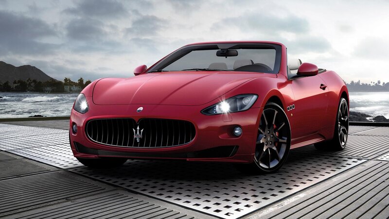 Red Maserati convertible by the sea