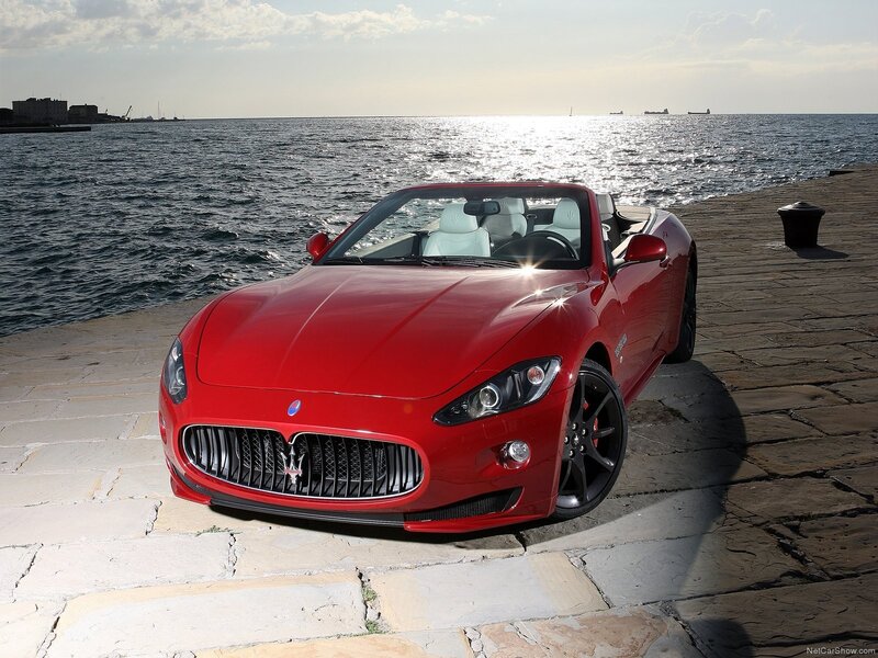 Red Maserati convertible by the sea