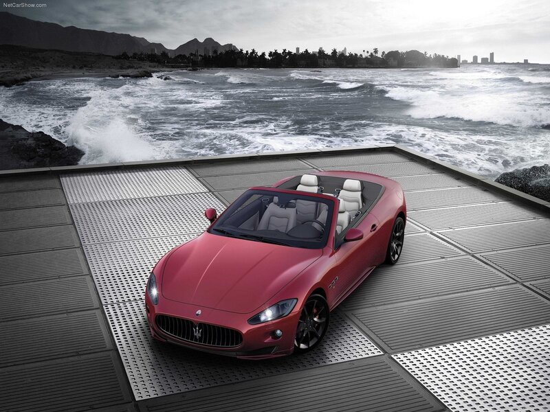 Red Maserati convertible by the sea
