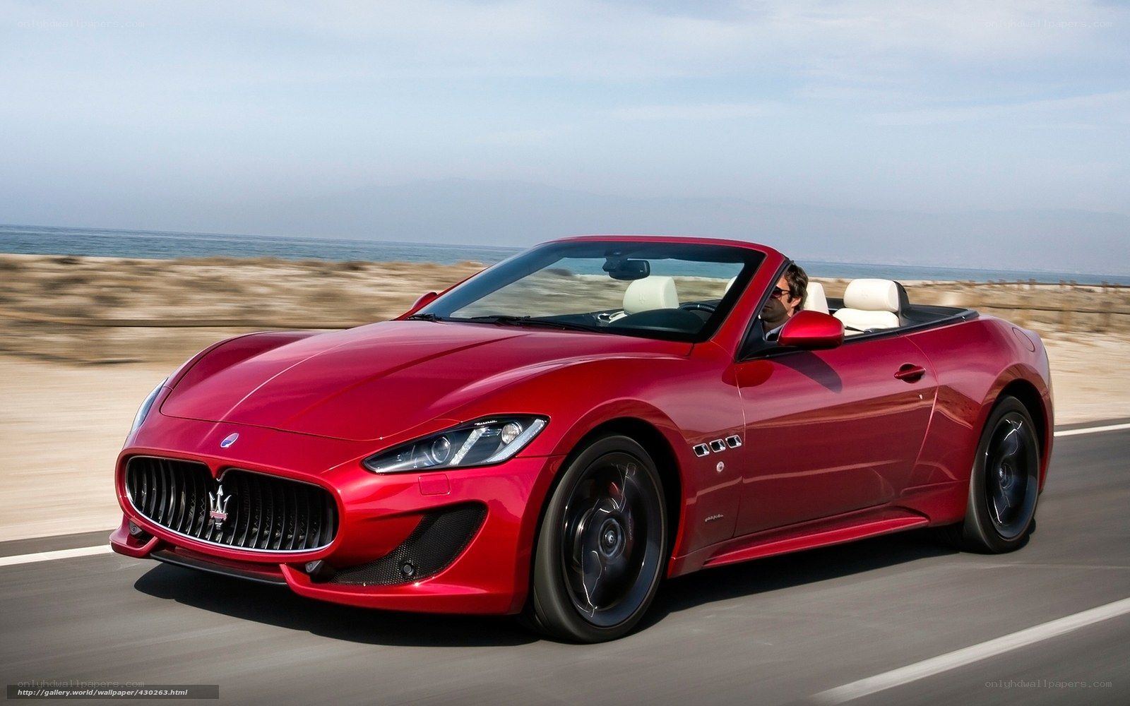 Red Maserati convertible on coastal road