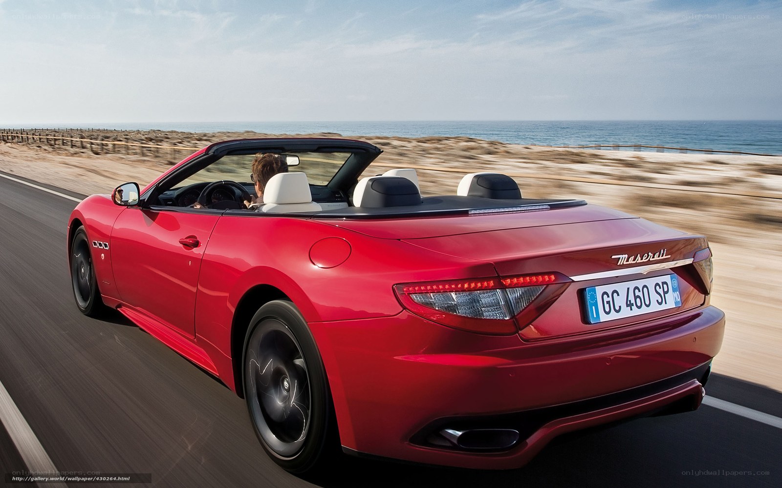 Red Maserati convertible on coastal road