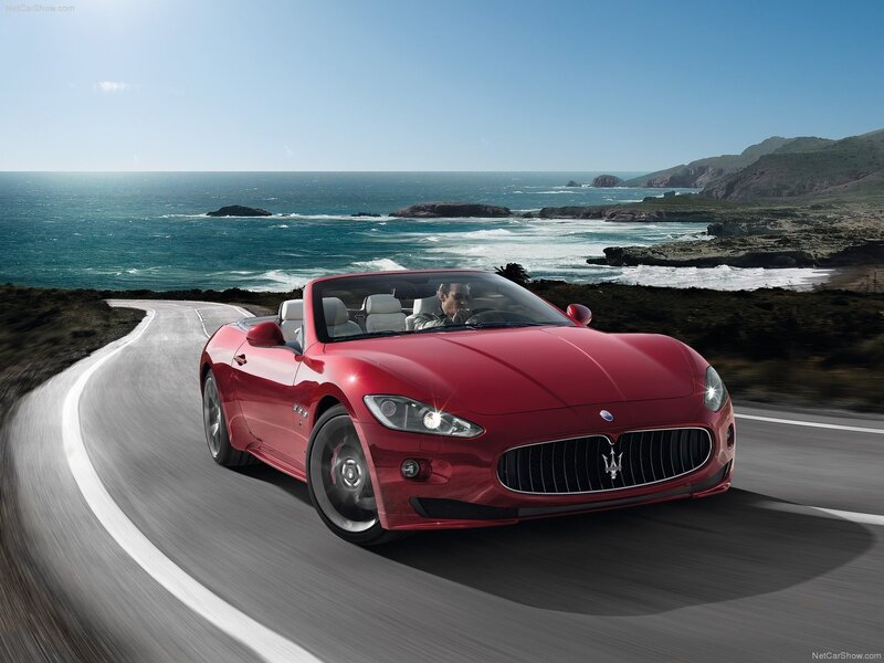 Red Maserati convertible on coastal road