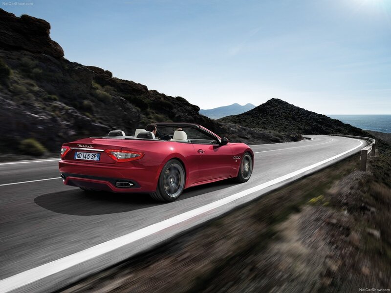 Red Maserati convertible on coastal road