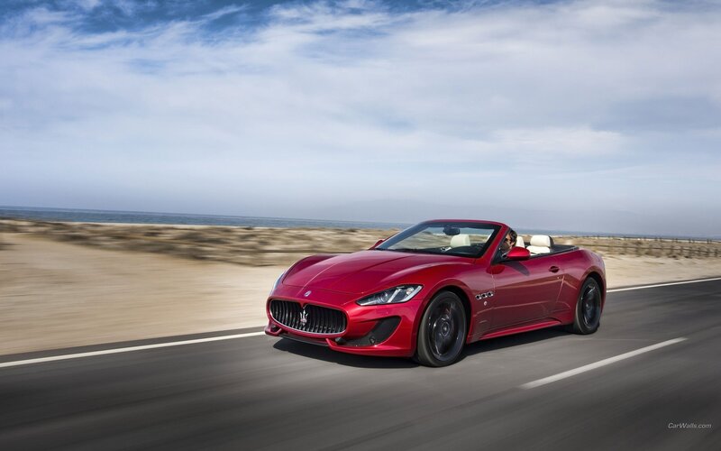 Red Maserati convertible on coastal road