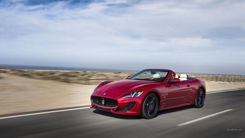 Red Maserati convertible on coastal road