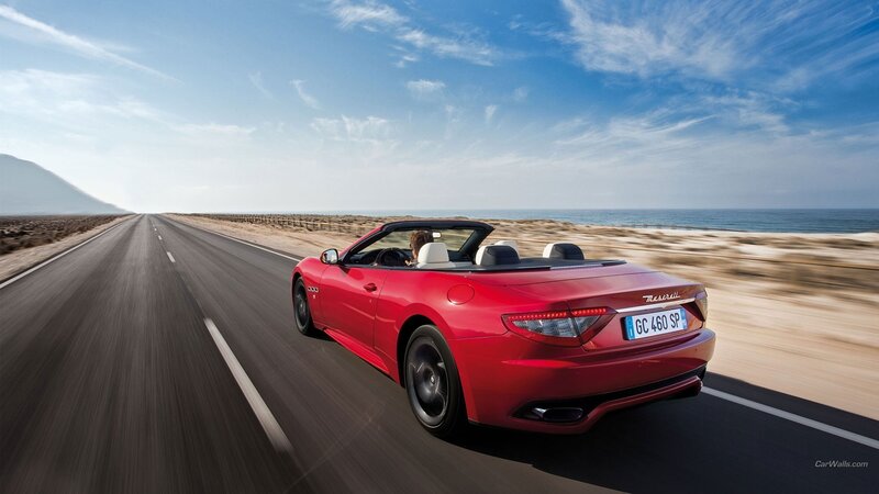 Red Maserati convertible on coastal road