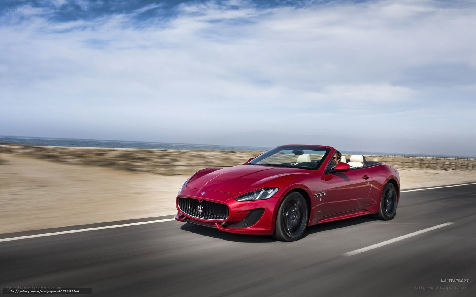 Red Maserati convertible on coastal road