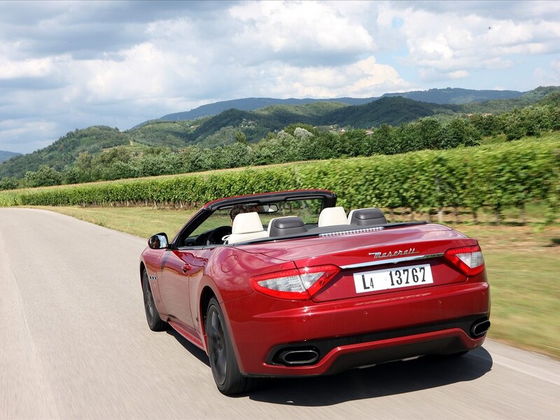 Red Maserati convertible on country road