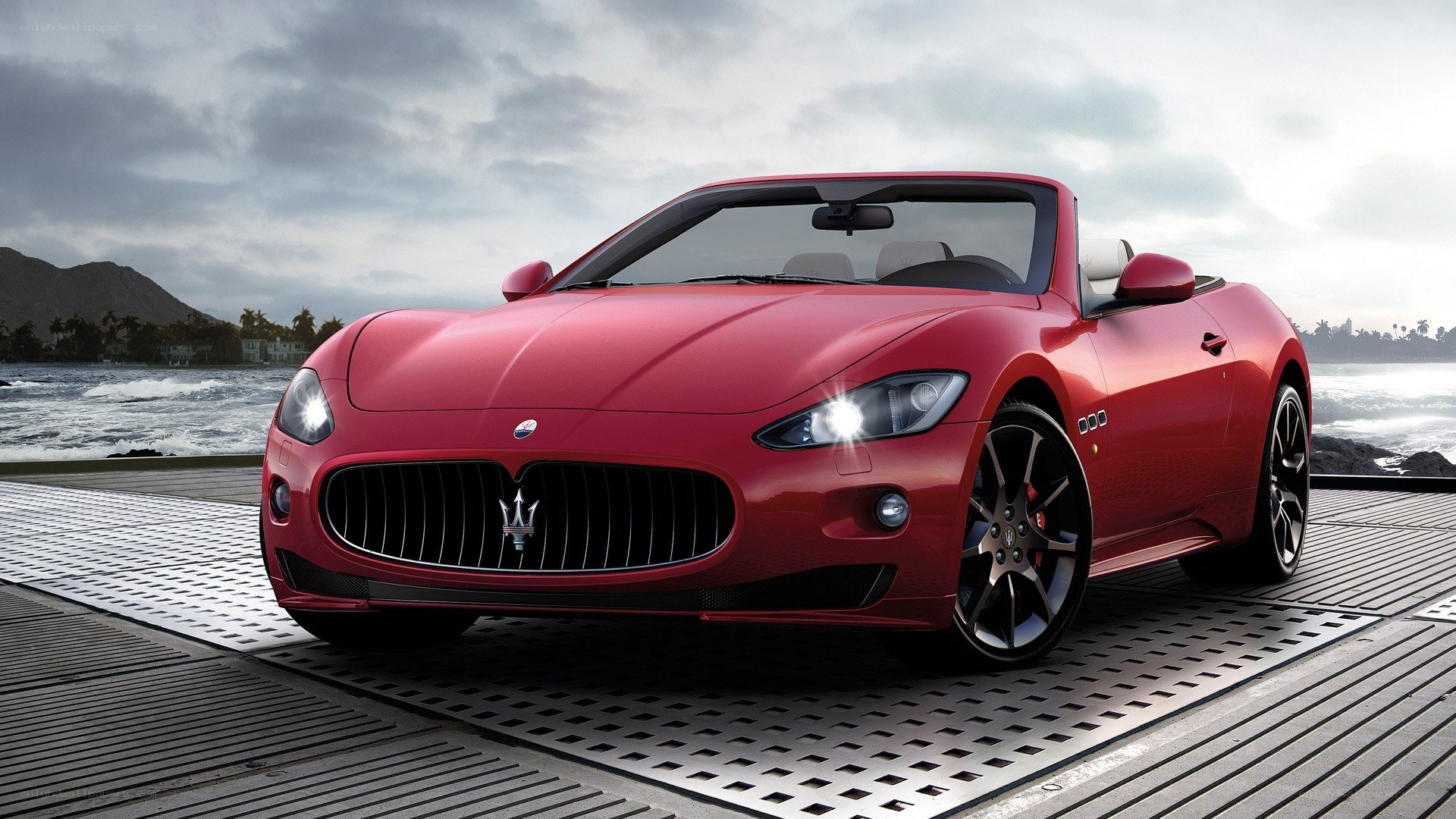 Red Maserati convertible on dock